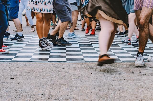 Close-up of people walking on busy street.