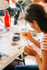 woman making bracelet