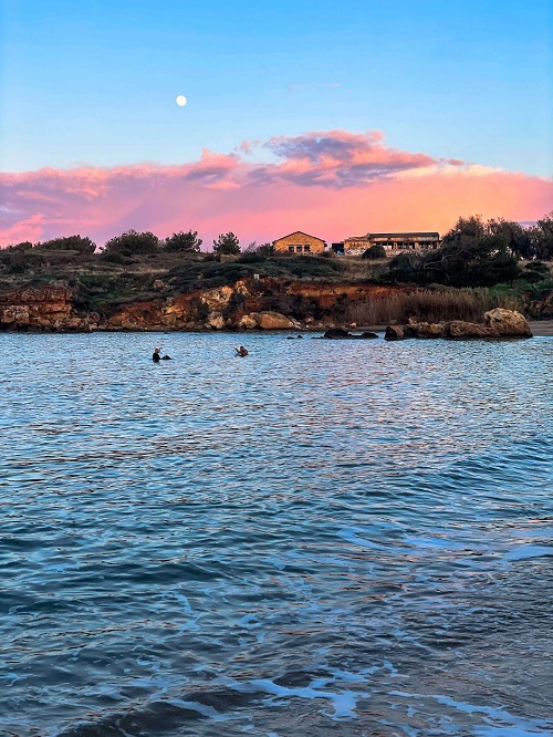 Writer’s photo of a beach at sunset in Greece.