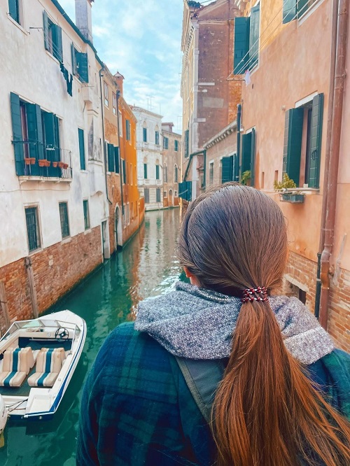 Photo of writer overlooking a canal in the Mediterranean.