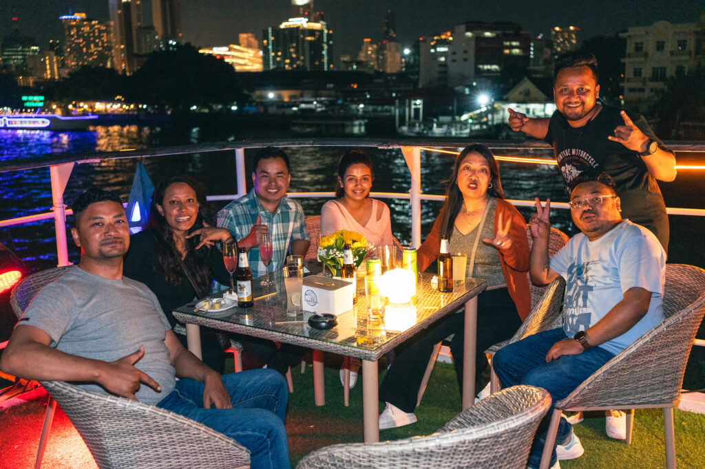 WordCamp Asia people at the GoDaddy boat party sitting at a table