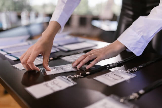 Someone organizing badges at a convention