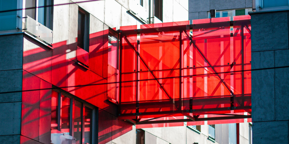 A red glass walkway over a building