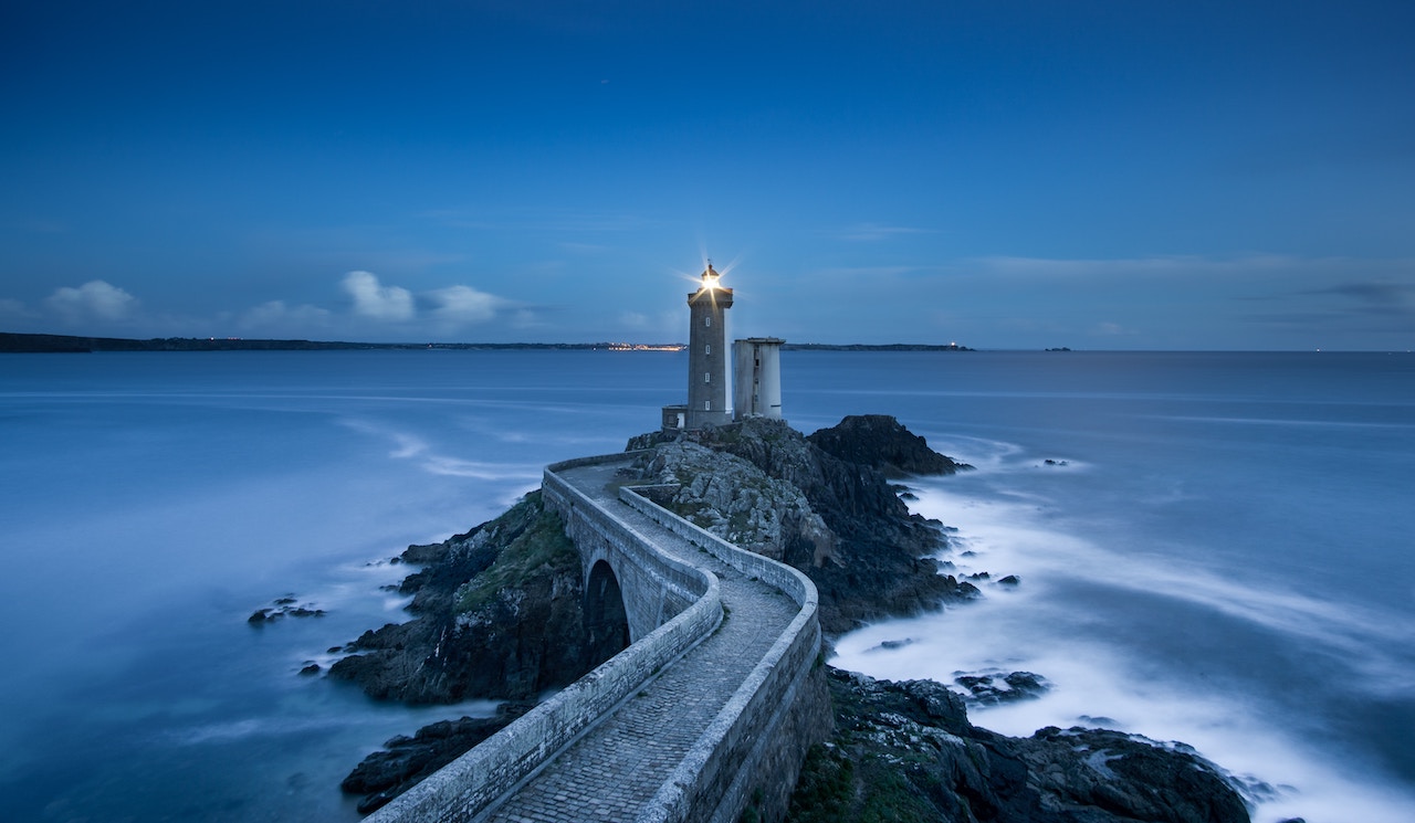 A stone bridge leading to a lighthouse