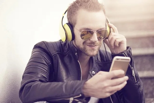 Do People Still Read Blogs- Man Listening to Audio on Smartphone