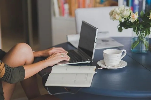 Do People Still Read Blogs - Woman Typing on Laptop with Teacup