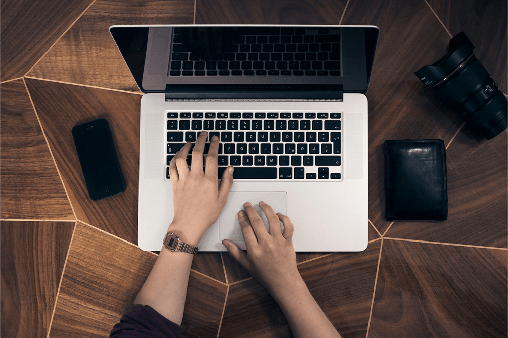 a person's hands on a laptop