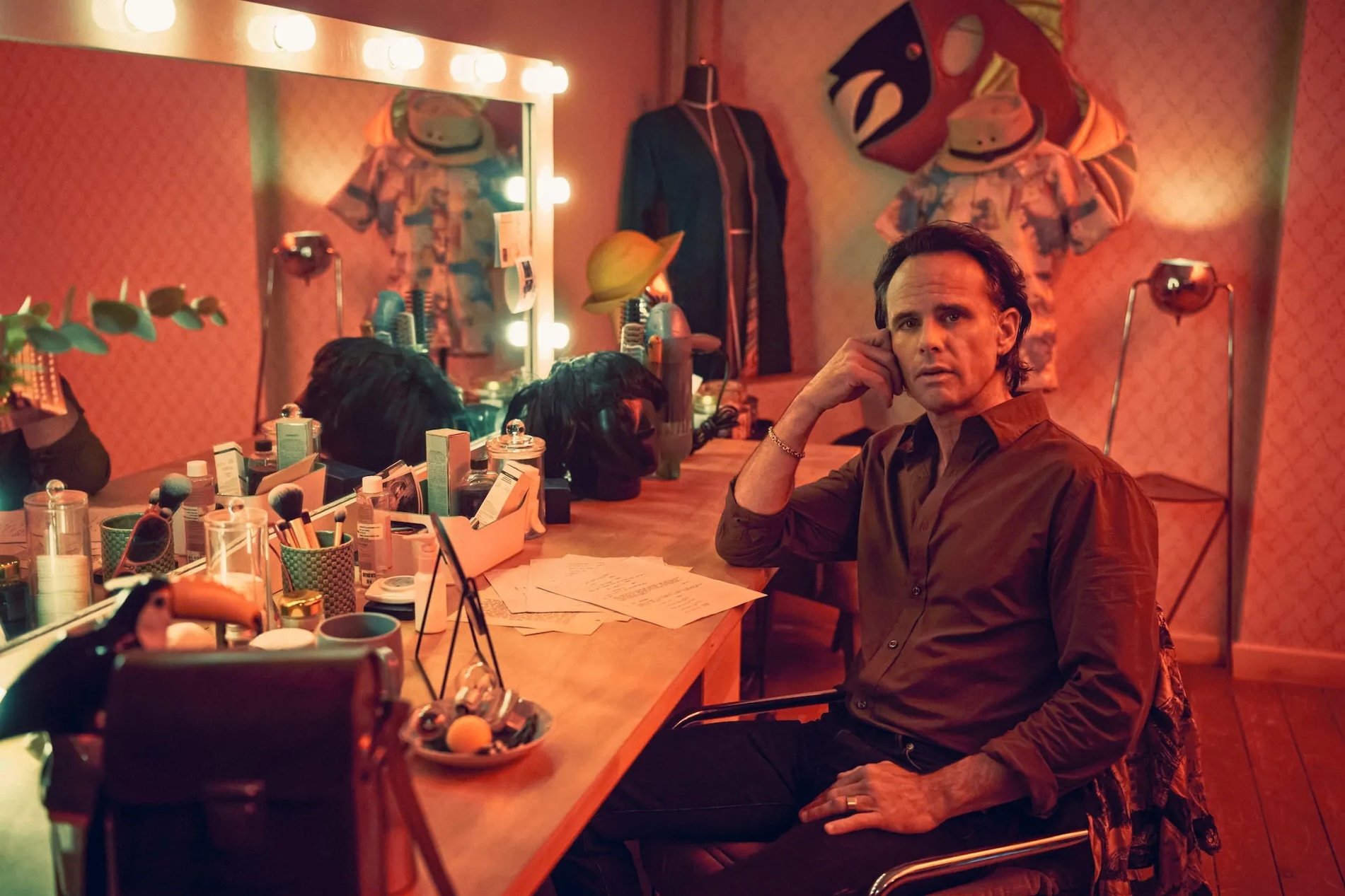 Walton Goggins sitting in the dressing room