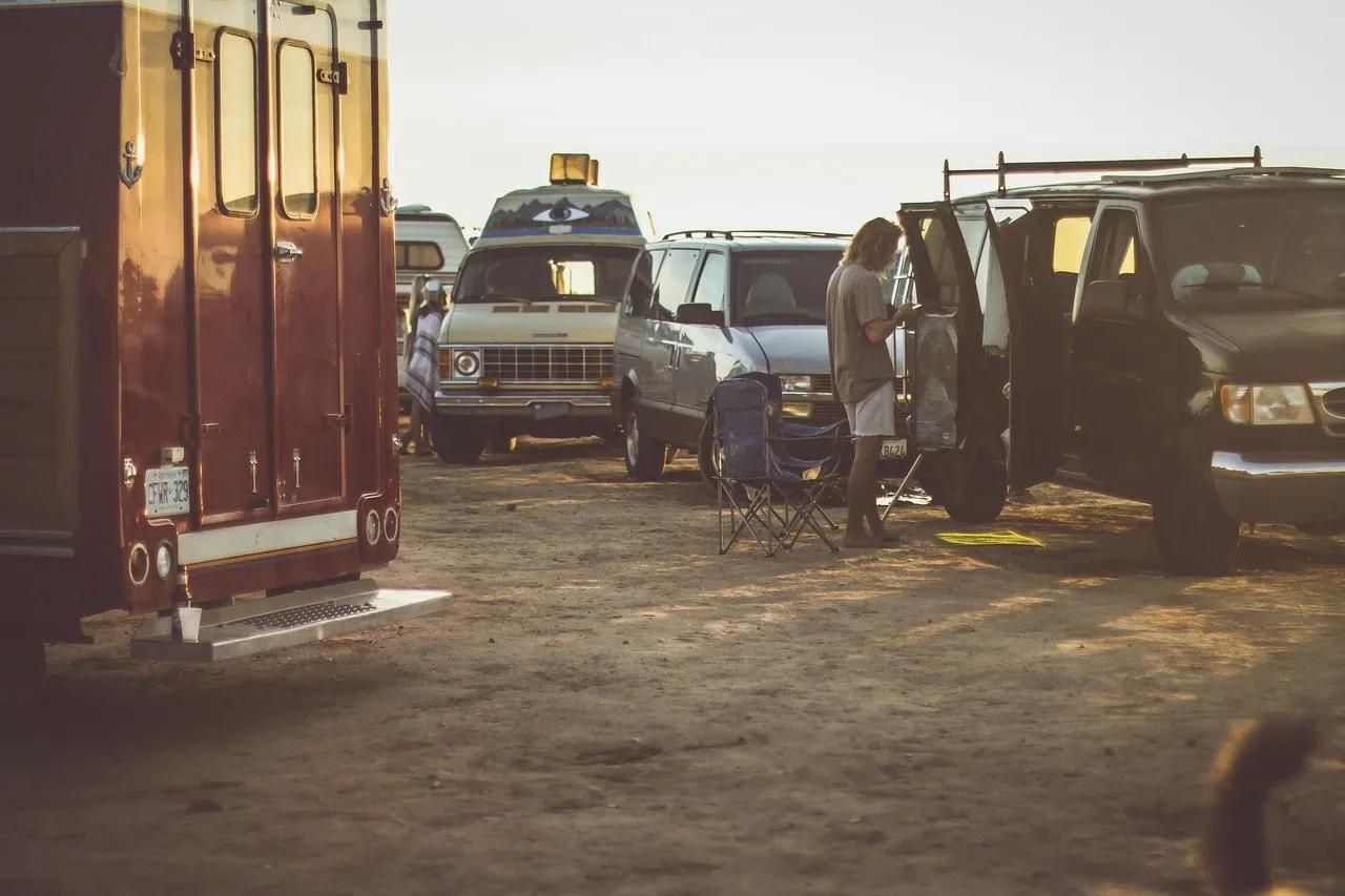 A Man Sets up Chairs outside His Camper Van