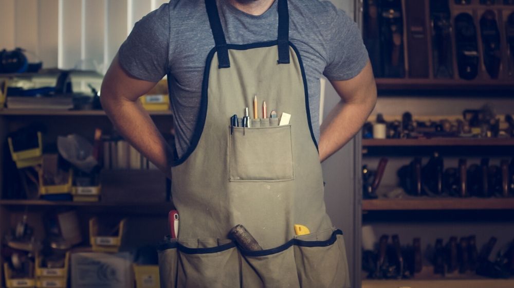 Man Wearing Apron With Tools Illustrates Best WordPress Plugins